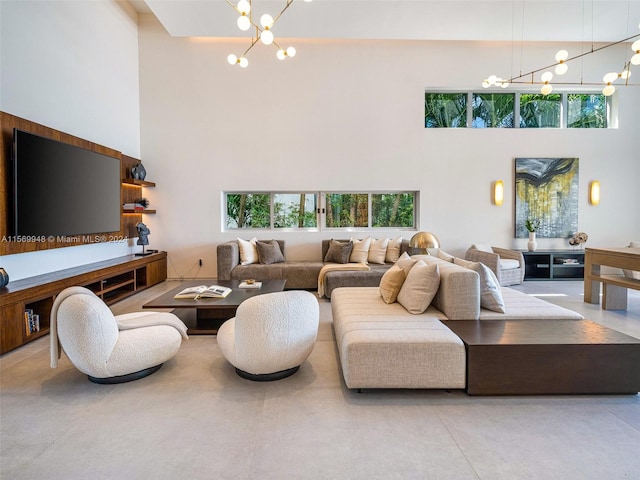 living room featuring an inviting chandelier and a high ceiling