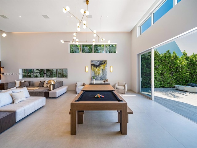 rec room featuring concrete floors, a high ceiling, and billiards