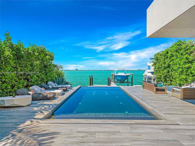 view of swimming pool with a water view and a dock