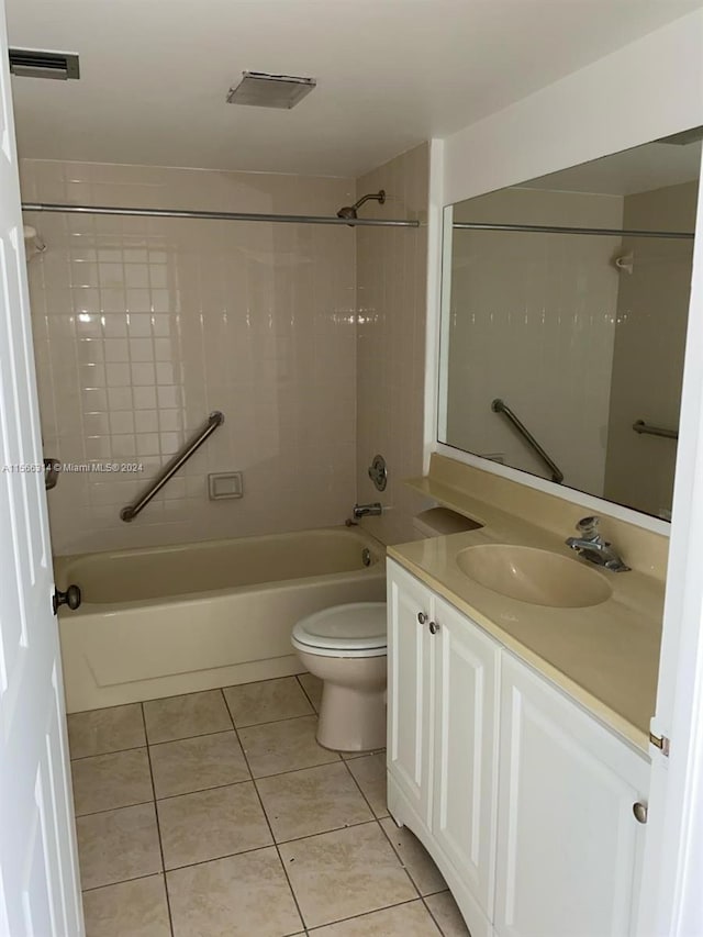 full bathroom with vanity, toilet, tiled shower / bath combo, and tile patterned flooring