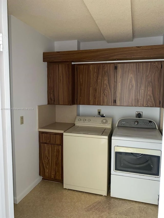 washroom featuring cabinets and washer and dryer