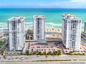 bird's eye view with a water view and a view of the beach