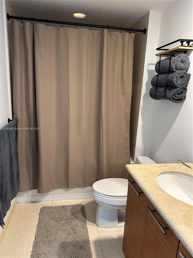 bathroom with vanity, tile patterned floors, and toilet