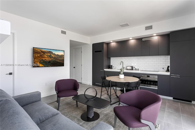 tiled living room featuring sink