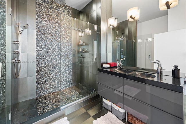 bathroom featuring a shower with door, oversized vanity, and tile flooring