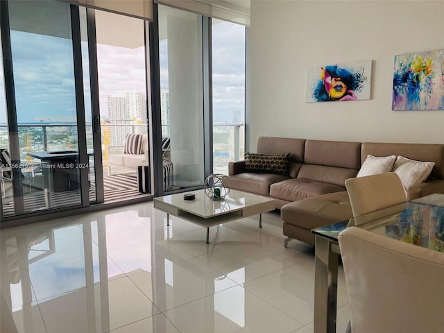 living room with a wall of windows and light tile patterned floors