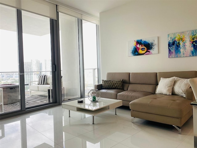 living room with light tile patterned flooring and a wall of windows