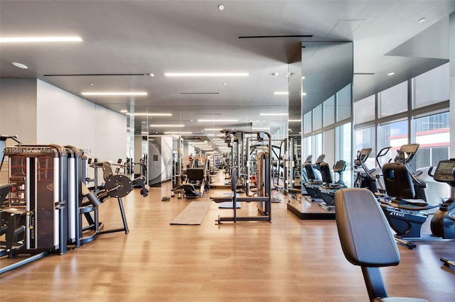 exercise room featuring light wood-type flooring