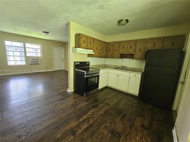 kitchen with dark wood-style flooring, light countertops, a sink, under cabinet range hood, and black appliances