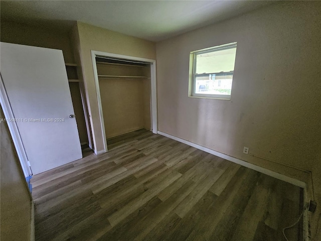 unfurnished bedroom with a closet and wood finished floors