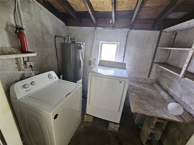 washroom with laundry area, water heater, and independent washer and dryer