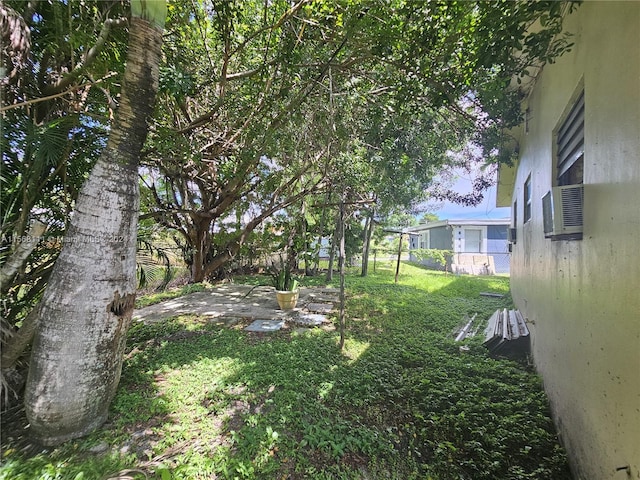 view of yard featuring fence and a patio