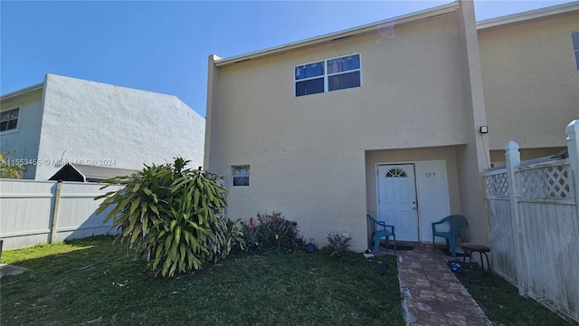 rear view of house featuring a yard