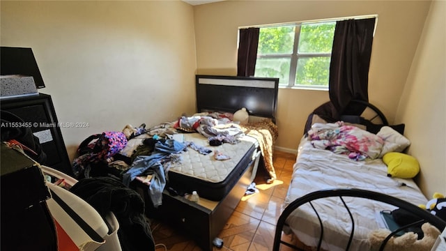 bedroom with light tile floors