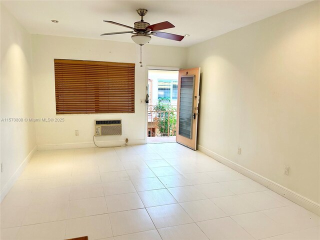 unfurnished living room featuring a wall mounted AC, ceiling fan, and light tile patterned floors