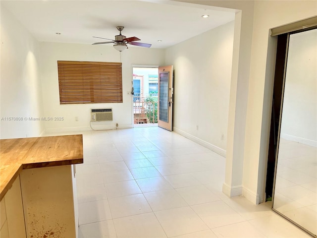 unfurnished living room featuring heating unit, ceiling fan, and light tile patterned floors