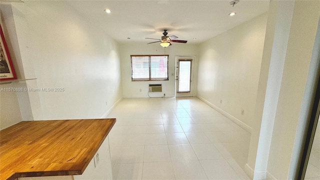 tiled empty room featuring ceiling fan and heating unit