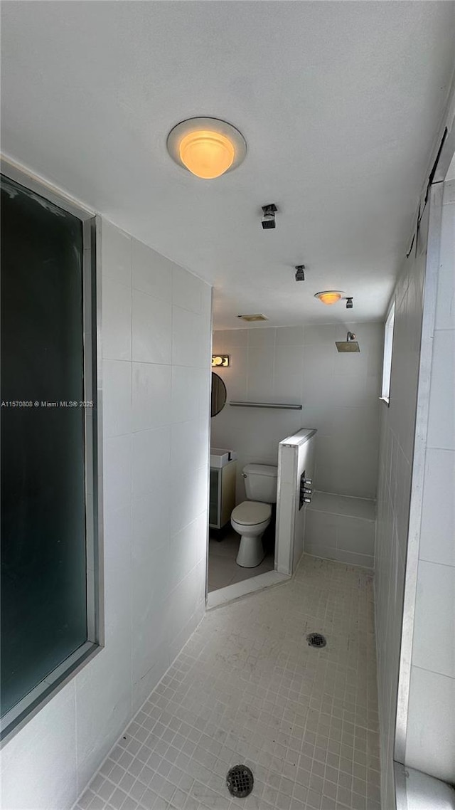 bathroom with tile patterned floors and toilet