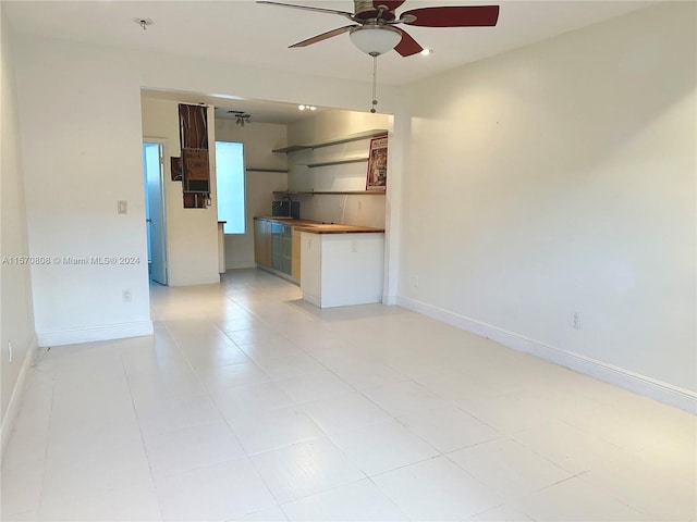 unfurnished living room with ceiling fan