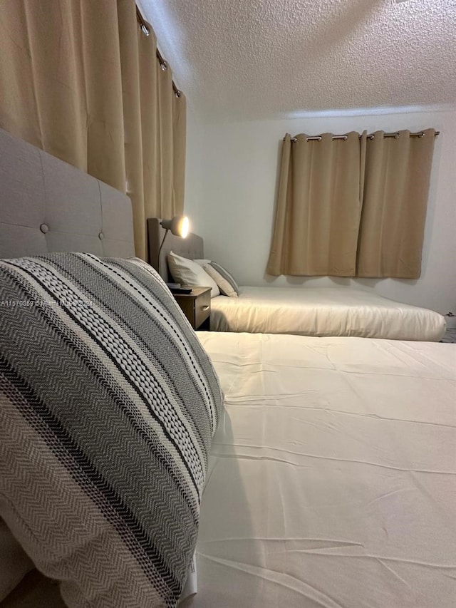 bedroom featuring carpet floors and a textured ceiling