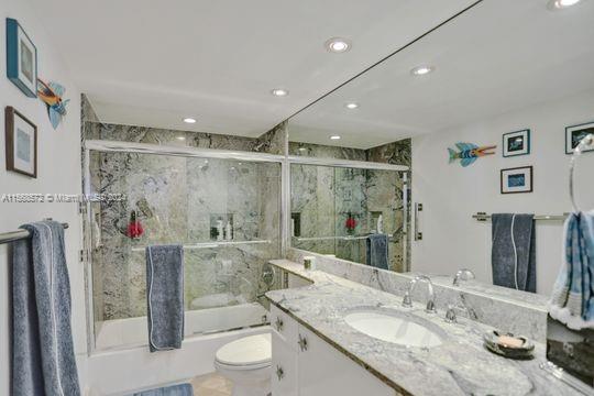 1121 Crandon Blvd Unit F906, Key Biscayne, FL 33149 - full bath featuring recessed lighting, bath / shower combo with glass door, toilet, and vanity