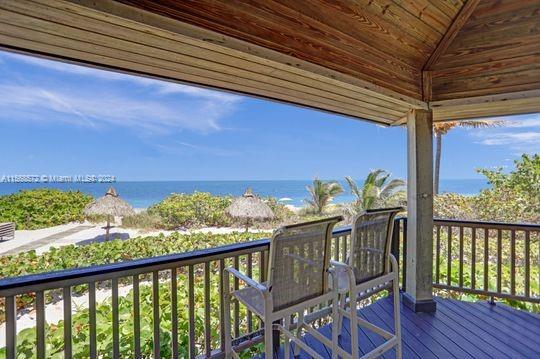 1121 Crandon Blvd Unit F906, Key Biscayne, FL 33149 - wooden terrace featuring a water view