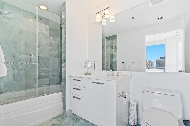 full bathroom featuring large vanity, toilet, enclosed tub / shower combo, and tile flooring