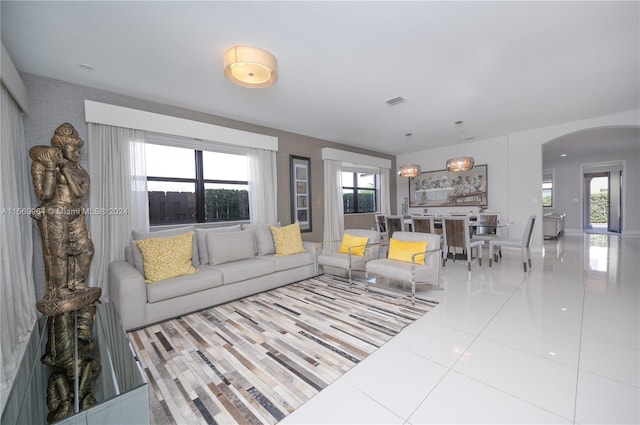 living room featuring a wealth of natural light and light tile floors