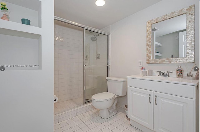 bathroom featuring walk in shower, toilet, tile floors, and vanity