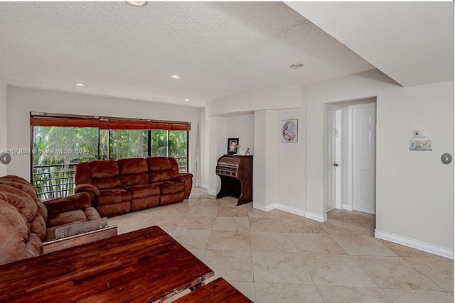 tiled living room featuring a textured ceiling