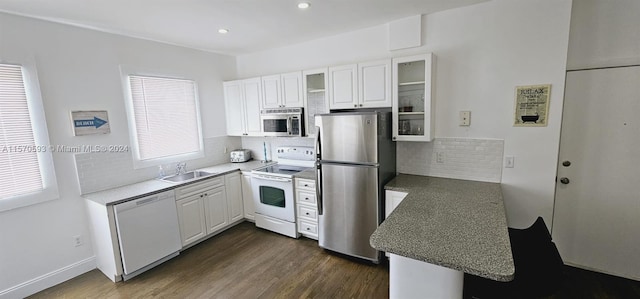 kitchen with white cabinetry, stainless steel appliances, a wealth of natural light, and dark wood-type flooring