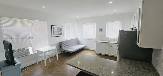 kitchen featuring white cabinets, sink, stainless steel fridge, dark hardwood / wood-style floors, and white dishwasher