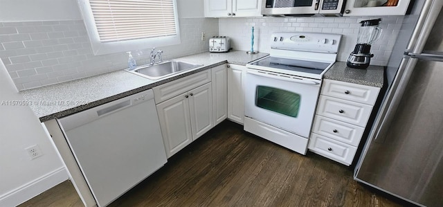 kitchen with white appliances, tasteful backsplash, white cabinetry, sink, and dark hardwood / wood-style flooring