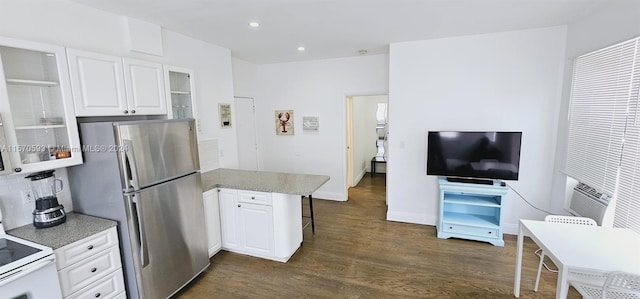 kitchen with stainless steel fridge, light stone counters, white cabinets, dark hardwood / wood-style flooring, and white range with electric stovetop