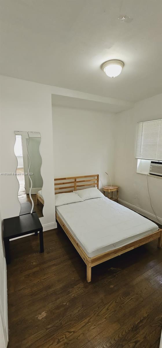 bedroom featuring dark wood-type flooring