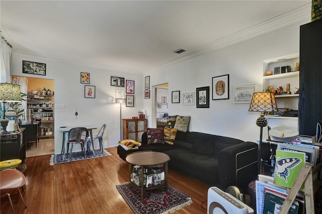 living room featuring dark hardwood / wood-style flooring and crown molding