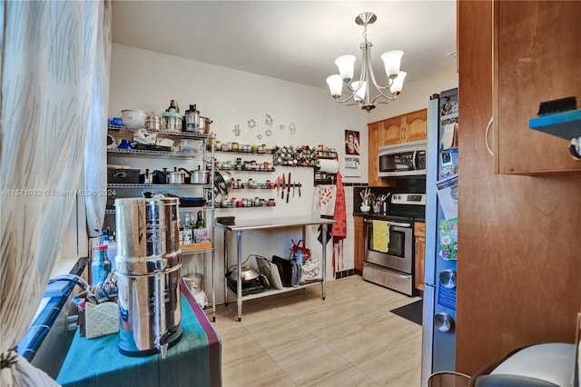 kitchen with a chandelier, stainless steel appliances, light tile floors, and hanging light fixtures