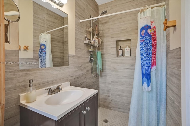 bathroom featuring vanity, tile walls, and a shower with shower curtain