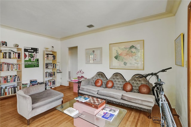 living room featuring crown molding and light wood-type flooring