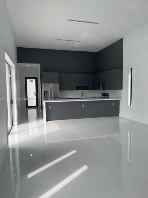 kitchen featuring a healthy amount of sunlight, appliances with stainless steel finishes, and light tile flooring