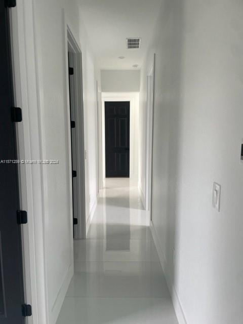 corridor featuring light tile flooring