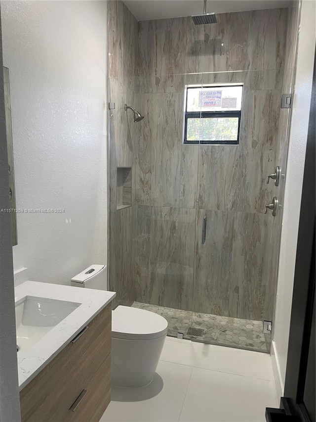 bathroom with walk in shower, vanity, toilet, and tile flooring