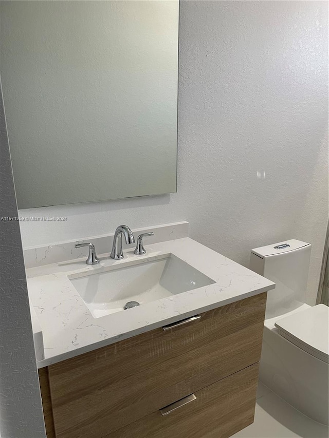 bathroom with vanity and toilet