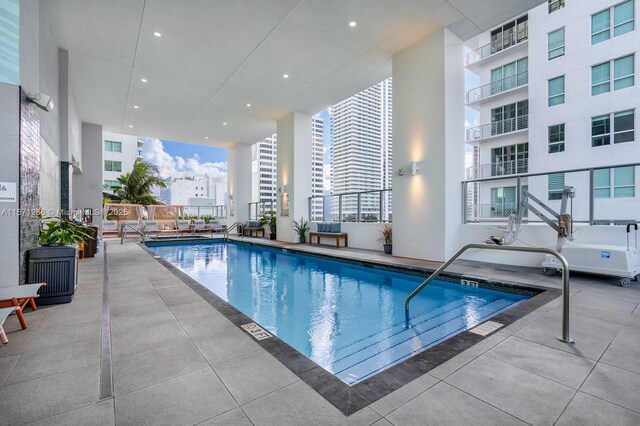 view of pool featuring an outdoor living space and a patio