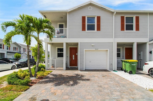 view of front of home featuring a balcony and a garage