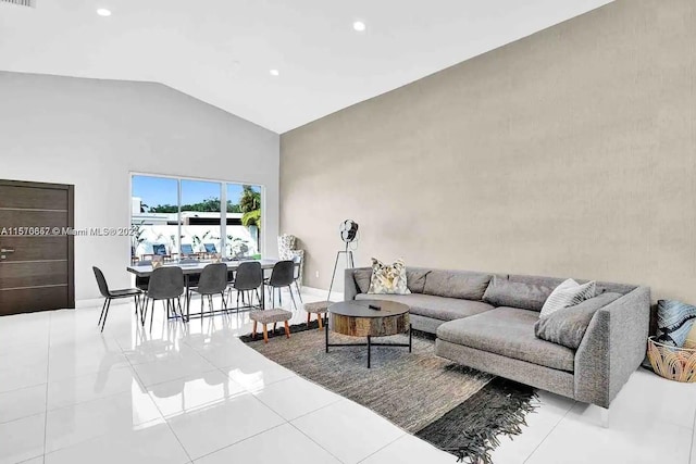 tiled living room featuring vaulted ceiling