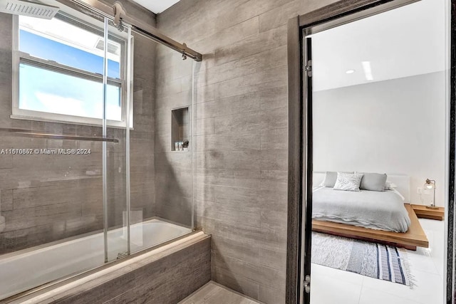 bathroom featuring combined bath / shower with glass door and tile flooring