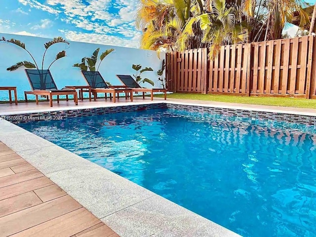 view of swimming pool featuring a patio area