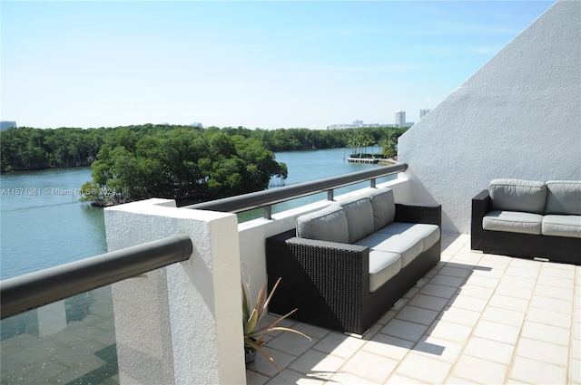 balcony with outdoor lounge area and a water view