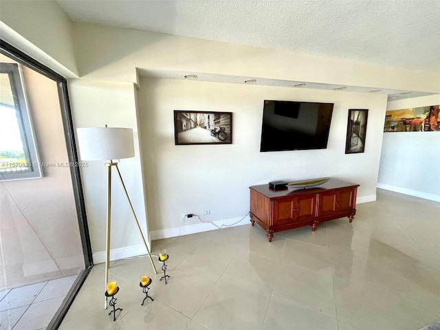 tiled living room featuring a textured ceiling